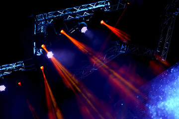 Fototapeta premium Crowd at concert - Cheering crowd in bright colorful stage lights