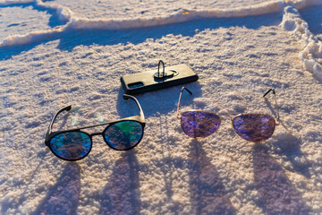 glasses, smartphone in the largest salt flat in Bolivia and the world