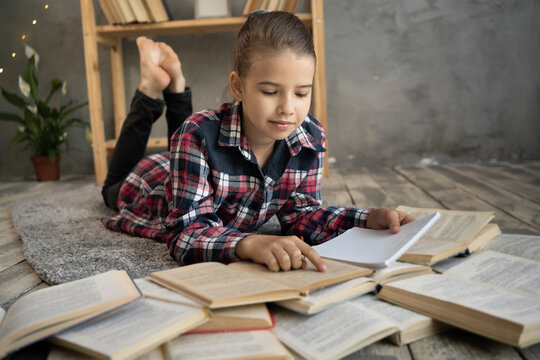 Education learning concept, schoolgirl with opening books or textbooks in library or home floor, stack piles of literature text academic archive in school study classroom