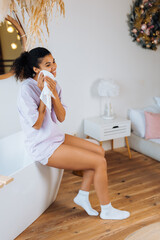 African american woman takes care of her skin in the bathroom