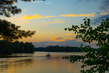 pontoon on lake with sunset