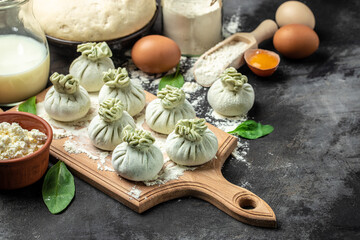 Georgian dumplings Khinkali with cheese and spinach. Raw semi-finished products dumplings. banner, menu, recipe place for text, top view