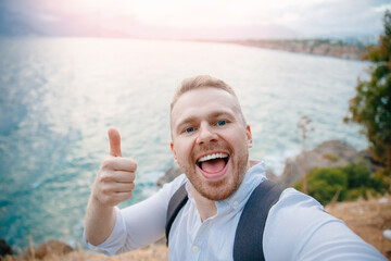 Happy man travel make selfie photo background of sunset in mountain Manavgat sea Antalya Turkey