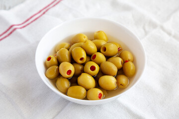 Marinated Green Olives with Pimento Peppers in a Bowl, side view.