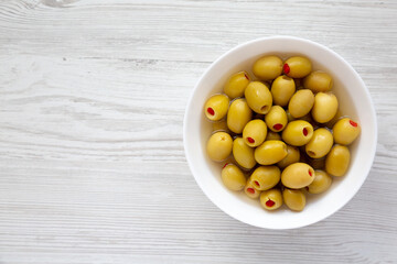 Marinated Green Olives with Pimento Peppers in a Bowl, top view. Flat lay, overhead, from above....