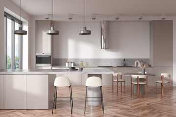 Light kitchen interior with dining table and countertop, kitchenware and window