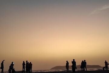 family on the beach at sunset