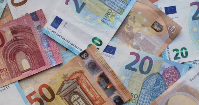 Euro banknotes in various denominations. Pile of banknotes on the table. Background of mixed euro banknotes