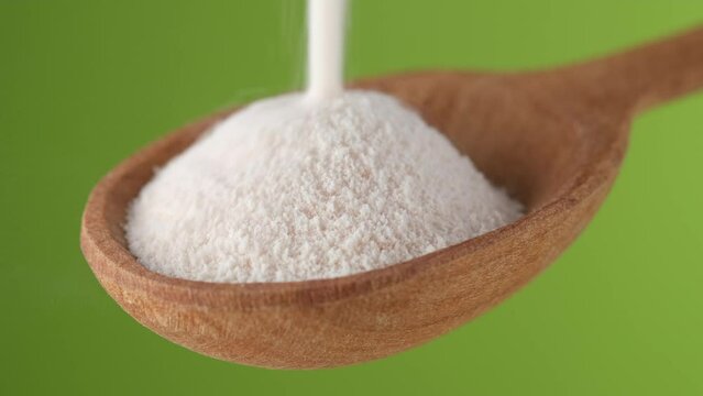 Collagen. Pouring collagen powder in wooden spoon. Natural beauty and health supplement