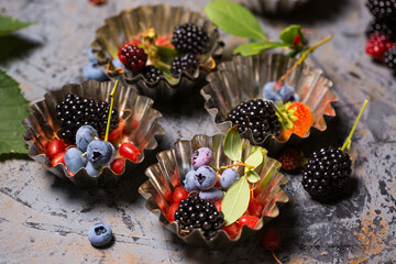 Assorted berries in vintage dishes