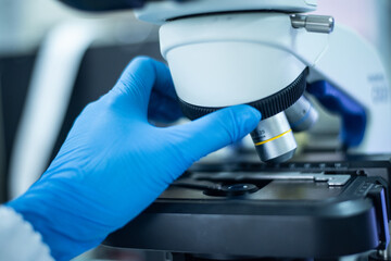 Hand scientist in blue glove.