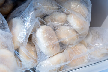Frozen bread in the refrigerator. ciabatta, loaf, hamburger buns - obrazy, fototapety, plakaty