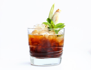 Exotic summer drinks idea. Espresso tonic non alcoholic cocktail tropical style in short glass garnish with mints and lemongrass isolated on white background