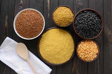 Different type of composition of raw dry legumes and cereals. Black beans, bulgur, peas and buckwheat.