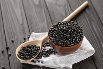 Fresh organic natural beans on wooden rustic black background