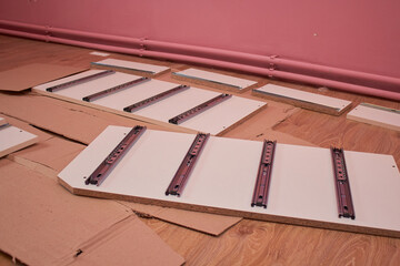 assemble furniture cabinets,disassembled furniture lying on the floor in the room