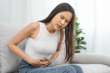 Flatulence asian young woman, girl hand in stomach ache, suffer from food poisoning, abdominal pain...