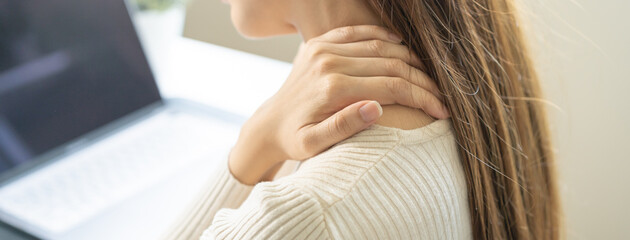 Body muscles stiff problem, ache asian young woman, girl pain neck while sitting work on chair at...