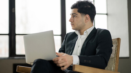 Fototapeta premium Freelancer man in a business suit chatting online video call with colleagues