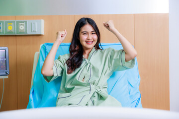 Happy excited successful Beautiful woman patient triumphing in modern hospital room success happy...