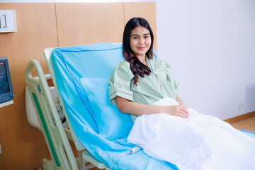 Happy smile successful Beautiful woman patient triumphing in modern hospital room EKG Monitor,...