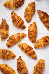 crispy ruddy croissants on a textured white fabric