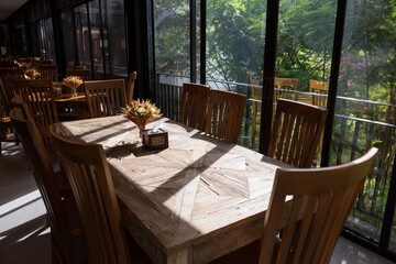 Restaurant wooden long table with green natural environment
