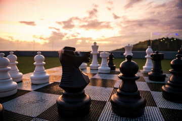 Big black horse chess decorated on roof top at sunset