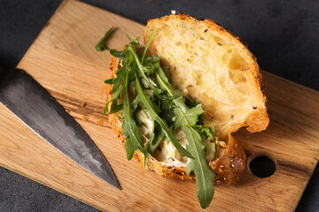 Croissant with sauce and arugula