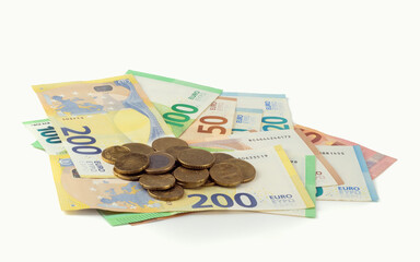 Euro banknotes, bills with change, cash paper money and coins isolated on bright background. Close up view.