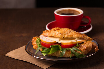 Croissant with turkey, cheese and aromatic coffee
