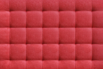 Red suede leather background for the wall in the room. Interior design, headboards made of furniture fabric, furniture upholstery. Classic checkered pattern for furniture, wall, headboard