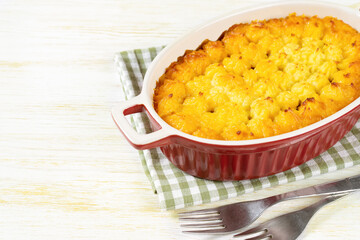 Shepherd's pie or Cottage pie. Minced meat, mashed potatoes and vegetables casserole on white wooden background with copy space for text. Traditonal British, United Kingdom, Ireland cuisine