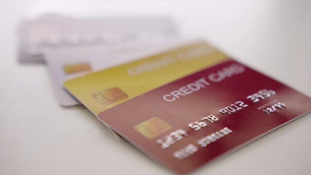 Closeup Shift Focus Credit cards Object on white table. 4K Video. Selective focus.
