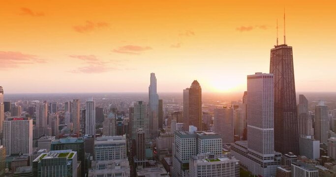 Beautiful Chicago panorama against wonderful orange sky. View of the city from aerial perspective.