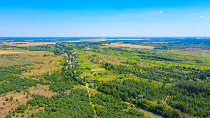 Beautiful summer landscape of a green valley. Aerial drone view over spring plain landscape.