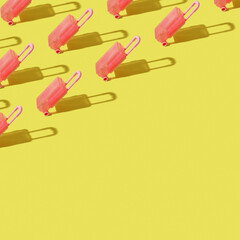 Pattern from toy suitcase on an orange background with a hard shadow. Copy space