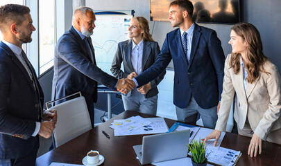 Business people shaking hands, finishing up a meeting.