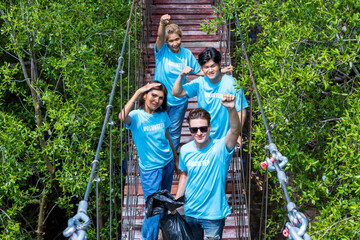 Team of young and diversity volunteer worker group enjoy charitable social work outdoor in cleaning up garbage project at mangrove forest