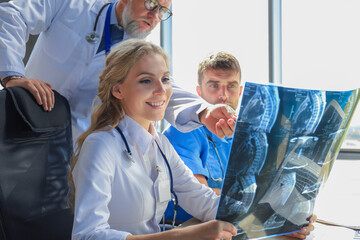 Group of doctors checking x-rays in a hospital.