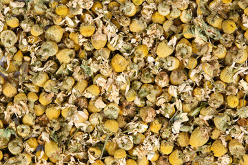 Close up of dried chamomile flowers (Matricaria chamomilla) photographed from above