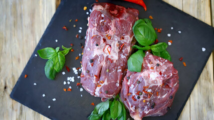 Soft focus. Pieces of raw lamb with spices on the board. Lamb marinade. © Oksana