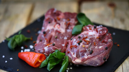 Soft focus. Pieces of raw lamb with spices on the board. Lamb marinade.