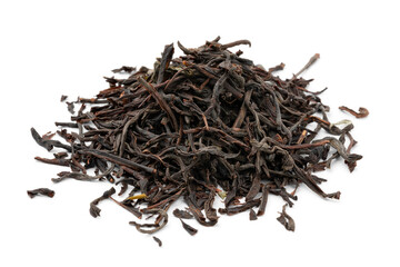 Heap of dried Ceylon blend tea leaves close up isolated on white background