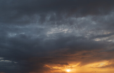 Fototapeta na wymiar Dramatic sunset with dark stormy clouds