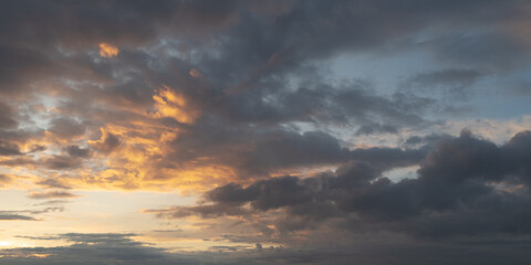 Naklejka na ściany i meble Dramatic sunset with dark stormy clouds