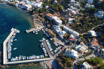 Aerial view of Mirties village marina on on sunny day. Kalymnos island, Aegean Sea, Greece.