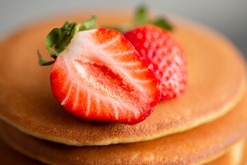 Pancakes for breakfast. Cover with pancakes. A stack of pancakes on a wooden board with honey. Honey pours on pancakes. Dessert. Favorite breakfast. Beautiful food cover.American breakfast. 