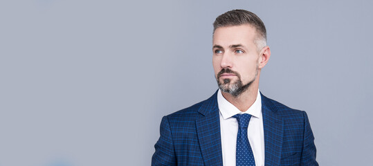 Mature businessman wear business suit in formal fashion style grey background, formalwear. Man face...