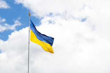 beautiful colored national flag of Ukraine on textured fabric, concept of emigration, politics and war in Ukraine. Ukrainian flags on transparent background of the sky. symbols. independent country